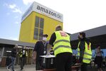 Striking Amazon employees stand outside an Amazon warehouse in Kobern-Gondorf, Germany, on June 29, 2020.