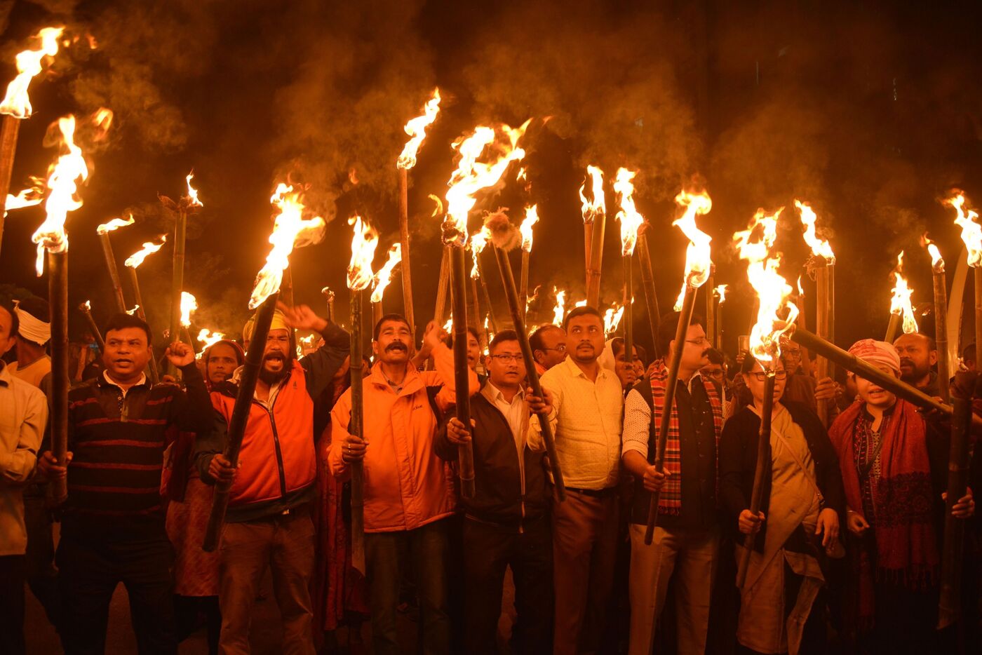 Protesters join a torchlight procession against the citizenship bill.