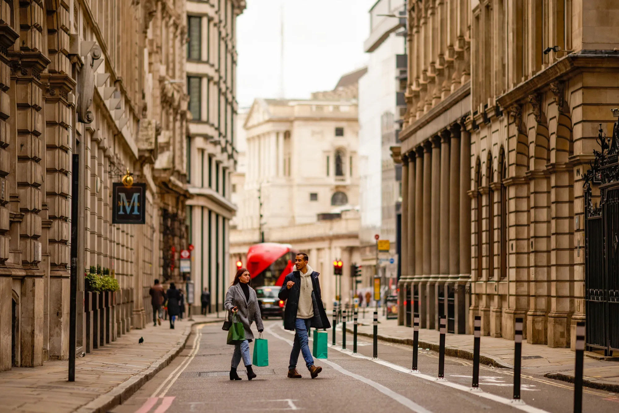 Pedestrians cross an empty street in the City of London, U.K., on Dec. 20.