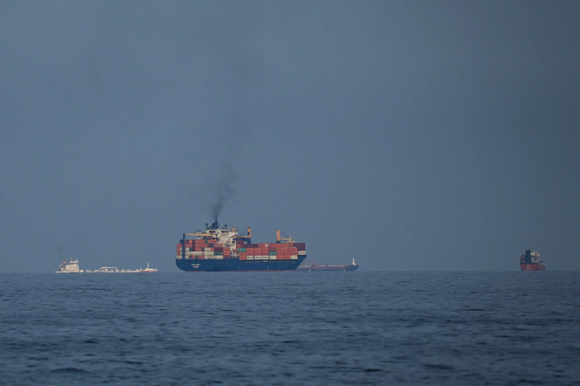 Oil tankers and cargo ships line up in the Strait of Hormuz as seen from Khor Fakkan, United Arab Emirates, in March.