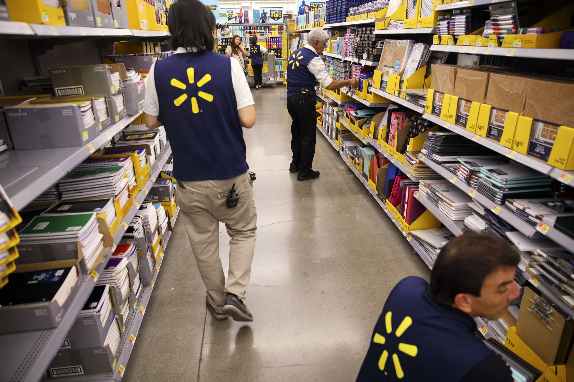 Employees restock shelves at a Wal-Mart Stores Inc. location in Burbank, Calif.
