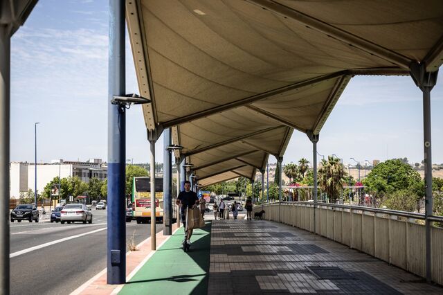 People walk on Christ of the Expiration bridge, the only one in Seville that has awnings that provide shade.