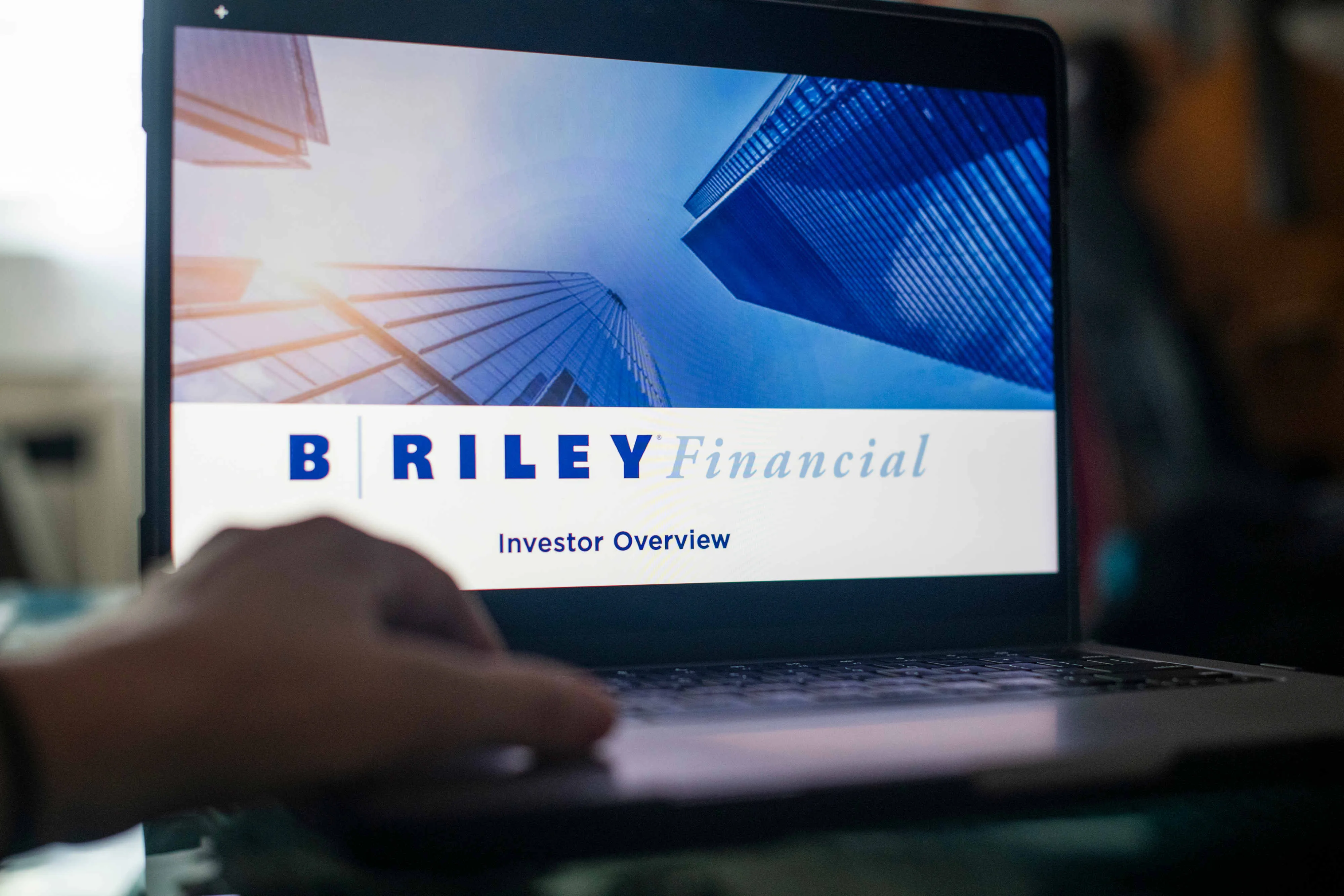 The B. Riley Financial Inc. logo on a laptop.