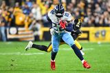 Derrick Henry of the Tennessee Titans runs for a first down at Acrisure Stadium on Nov. 2
