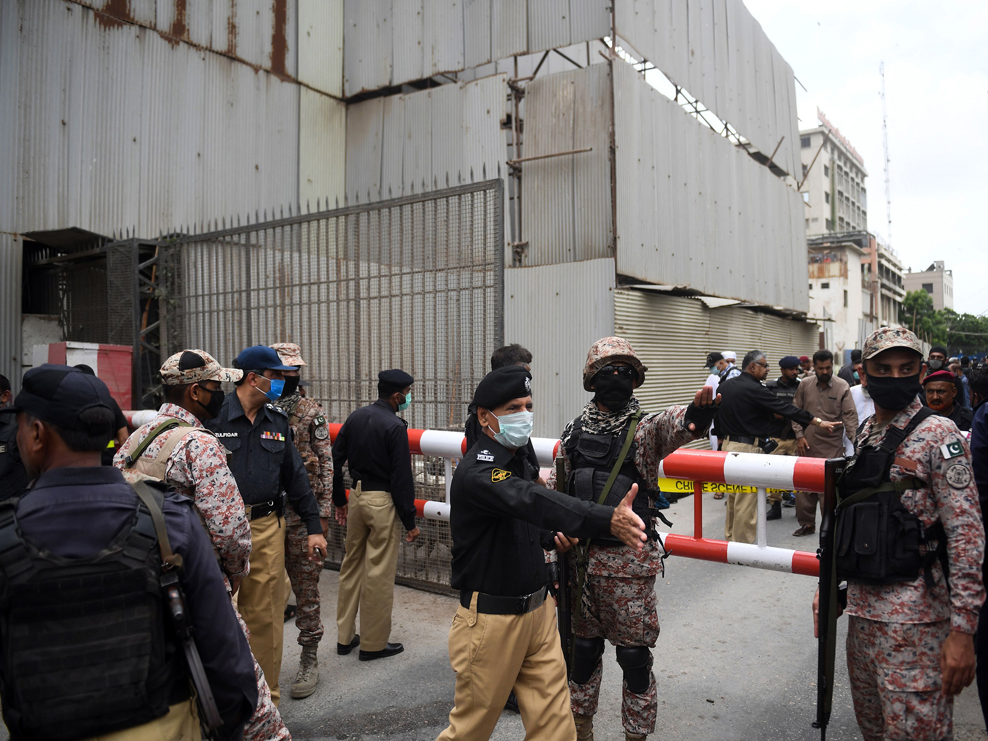 Security personnel gather at the main entrance of the Pakistan Stock Exchange building in Karachi, Pakistan, on June 29.