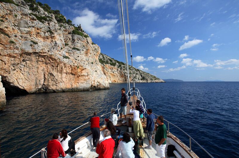 People. tourists on a boat. sailing ship. the Blue Cave in the sea of ​​Alonissos Marine Park. Sporades Islands. Greece