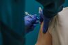 A healthcare worker receives the Pfizer-BioNTech Covid-19 vaccine at McLeod Health Clarendon Hospitals in Manning, South Carolina, U.S., on Thursday, Dec. 17, 2020. The first Covid-19 vaccine shots were administered by U.S. hospitals Monday, the initial step in a historic drive to immunize millions of people as deaths exceed the 300,000 mark.