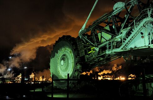 A disused mining machine is displayed in front of an oil sands extraction facility near the town of Fort McMurray, Alberta, Canada. Photographer: Mark Ralston/AFP via Getty Images