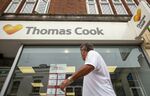 A pedestrian passes a Thomas Cook Group Plc travel agency store in East Grinstead.