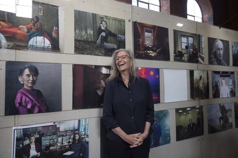 Annie Leibovitz poses with her photographs at the launch of Women: New Portraits, on view in London until Feb. 7. The international touring exhibition was commissioned by UBS.