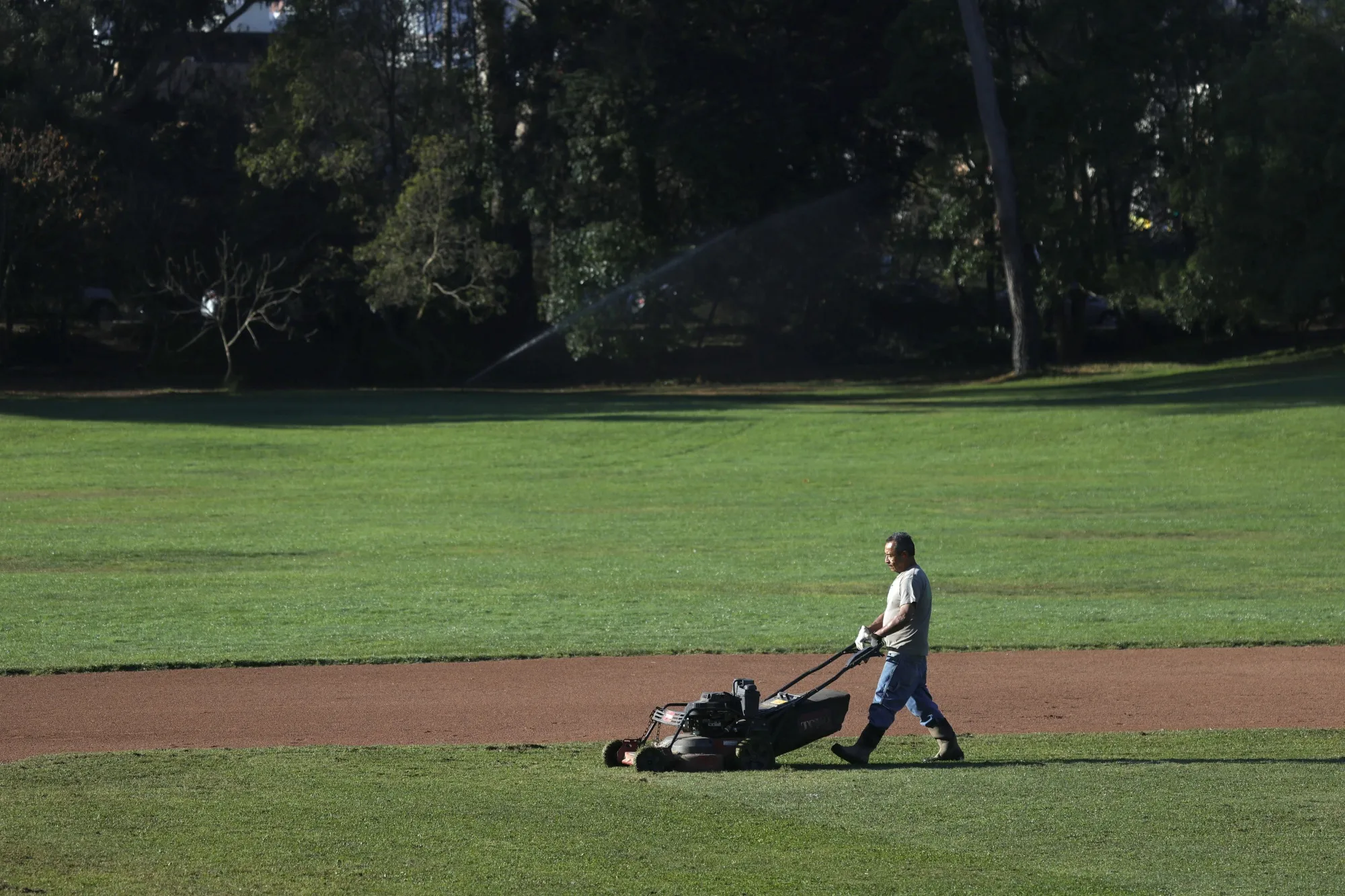 A San Francisco Recreation and Parks worker uses a gas-powered mower to cut the grass at Golden Gate Park.