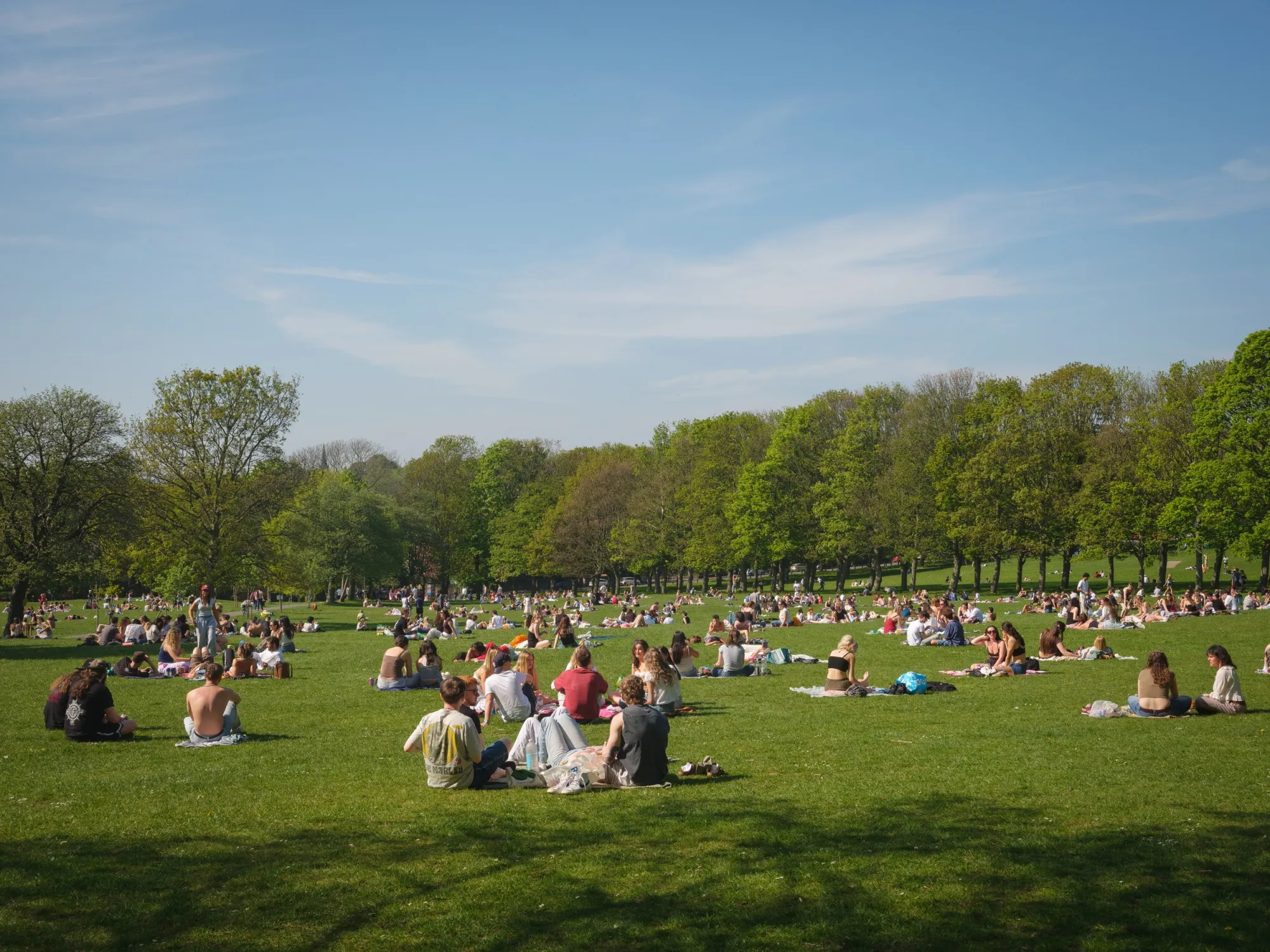 People enjoy the sunshine in Hyde Park, a popular green space at the heart of Leeds’ student district, as more graduates weigh further study to improve their job prospects.