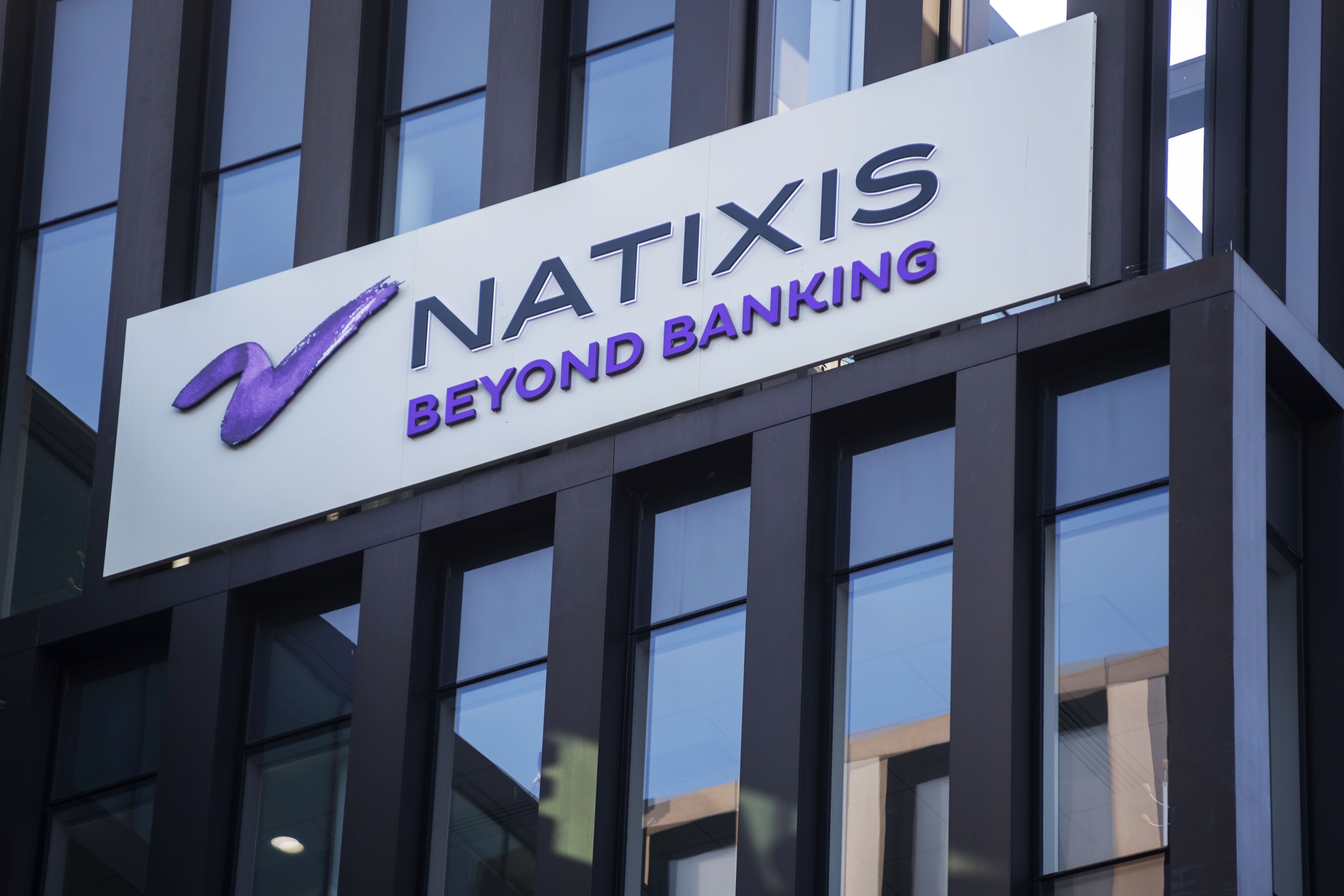 The Natixis SA logo sits on a sign outside the company's headquarters in Paris, France, on Saturday, June 29, 2019.