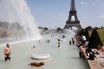 Parisians cool off in the fountains of the Trocadero Gardens earlier this week