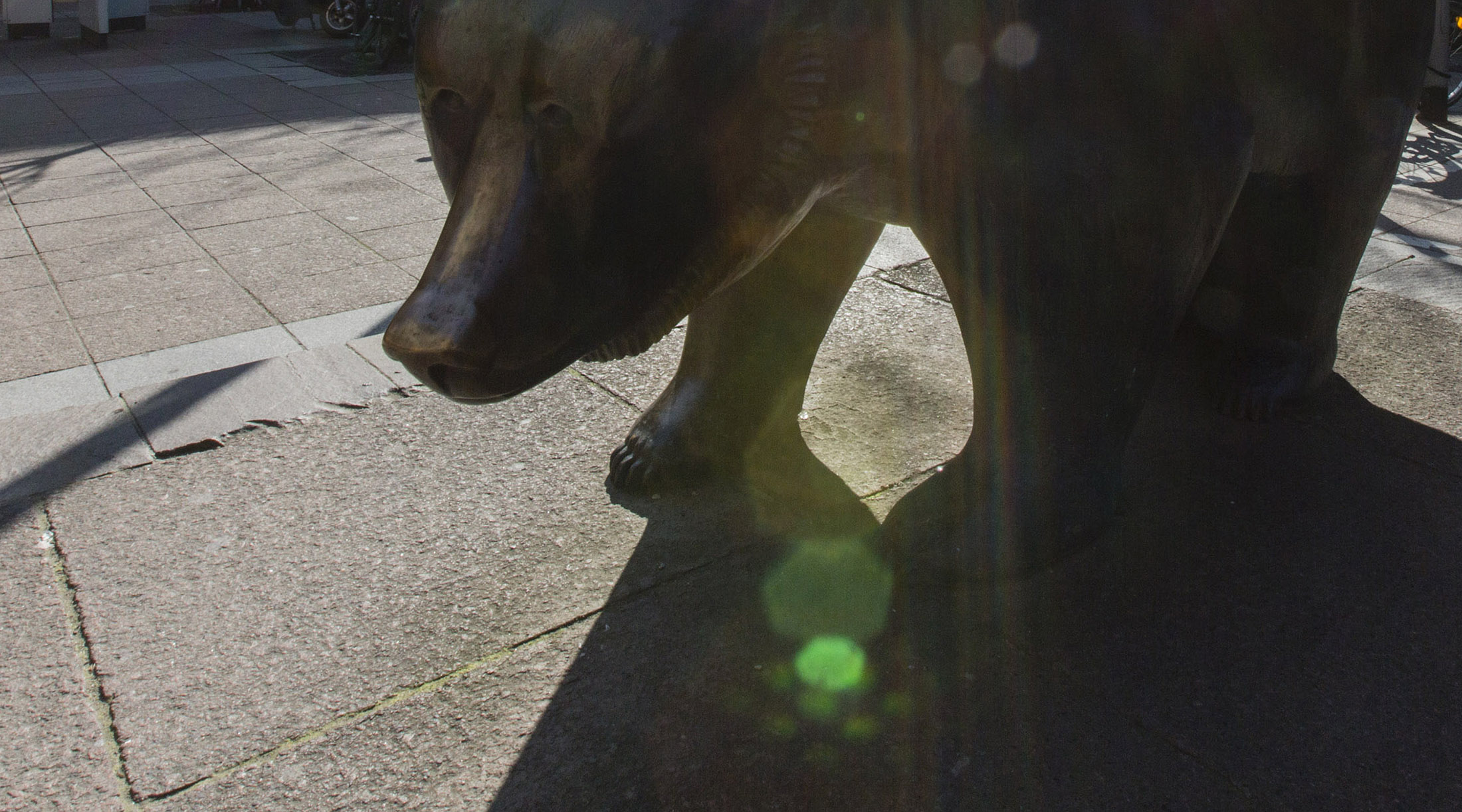 A bear statue stands as the sun shines outside the Frankfurt Stock Exchange in Frankfurt.
