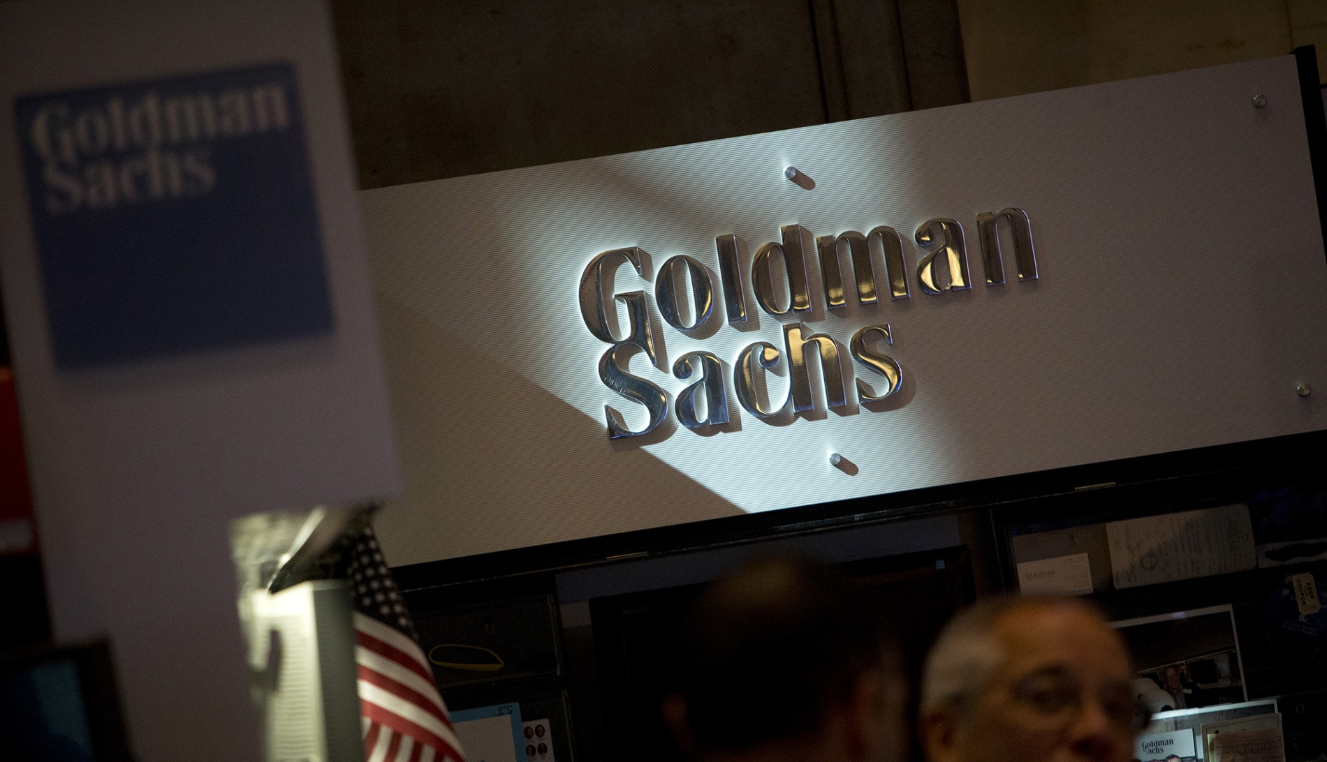 The Goldman Sachs & Co. logo is displayed at the company's booth on the floor of the New York Stock Exchange.