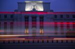 The Marriner S. Eccles Federal Reserve building stands past passing vehicles in Washington, D.C.