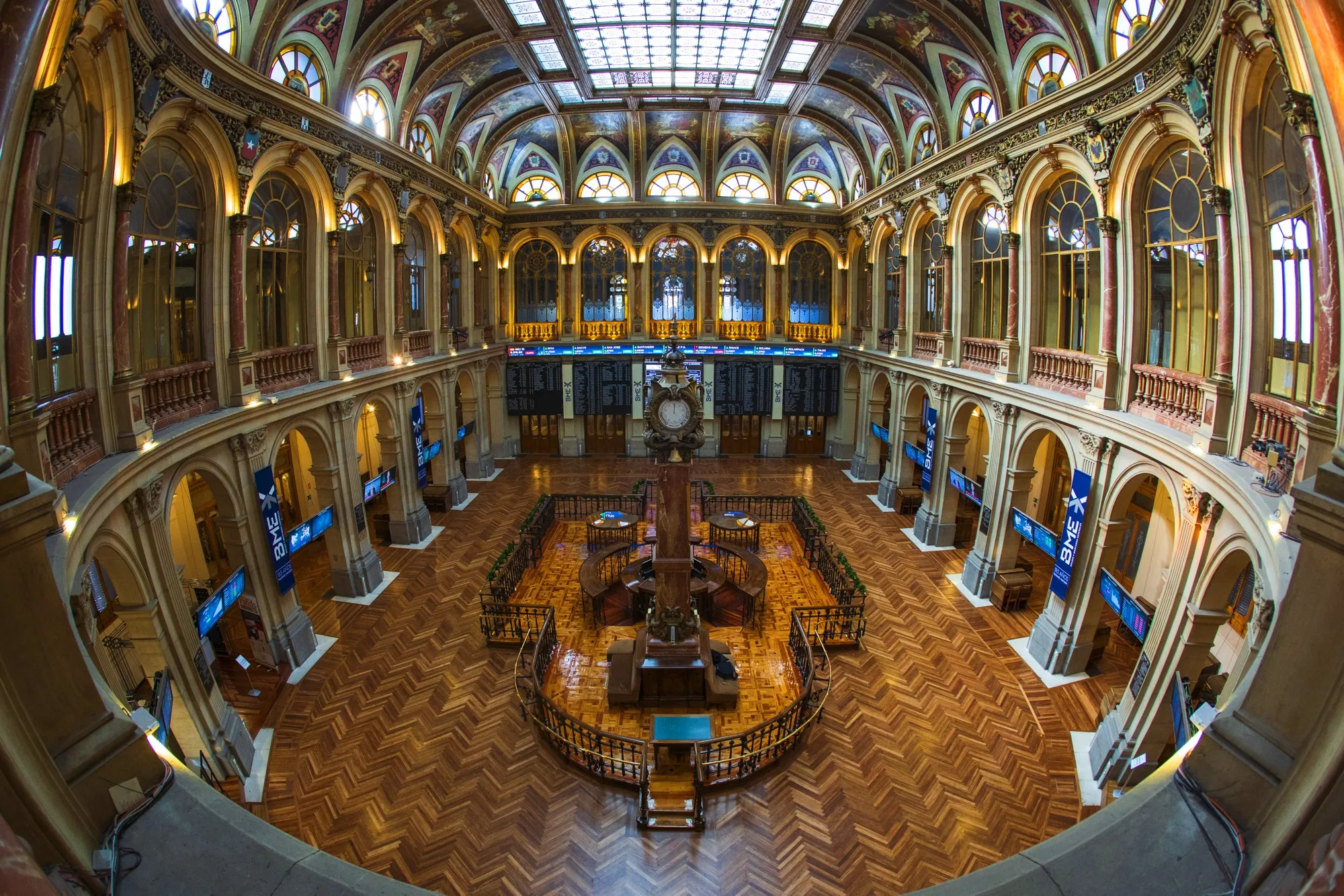 Electronic ticker boards sit on display in the main hall of the Madrid stock exchange.