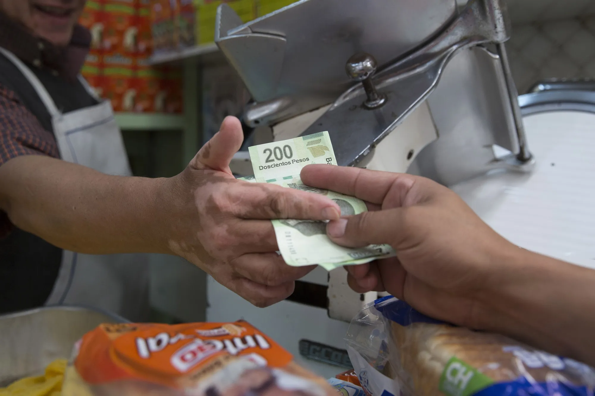 A customer pays for products&nbsp;at the Medellin market in Mexico City, Mexico.