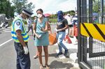 Police check ID as people enter a Shopping Mall in Mahebourg, Mauritius.