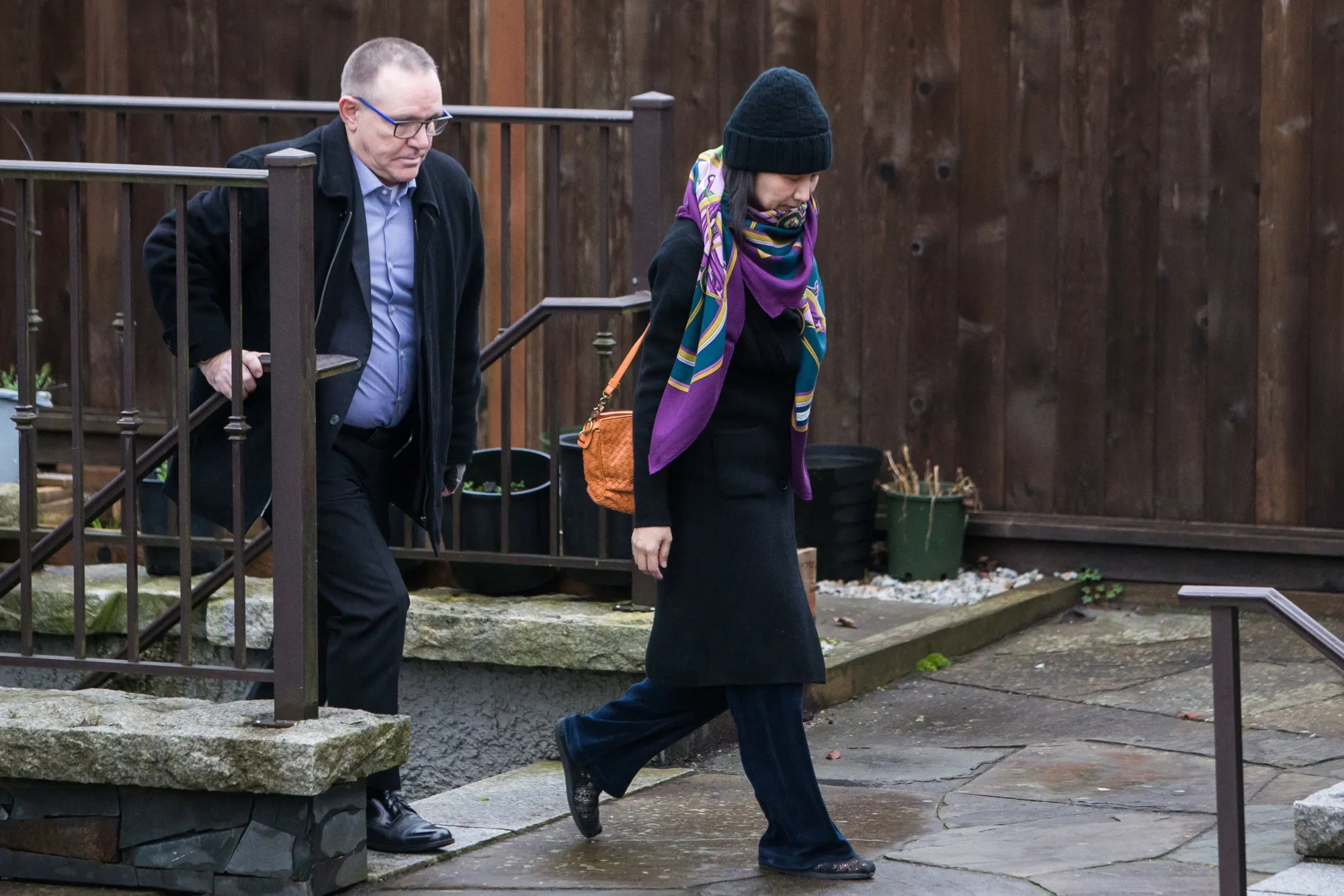 Meng Wanzhou leaves her home under the supervision of security on Dec. 12.