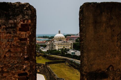 The Capitol Building is seen past walls in the Old City of San Juan, Puerto Rico, on July 8, 2015.