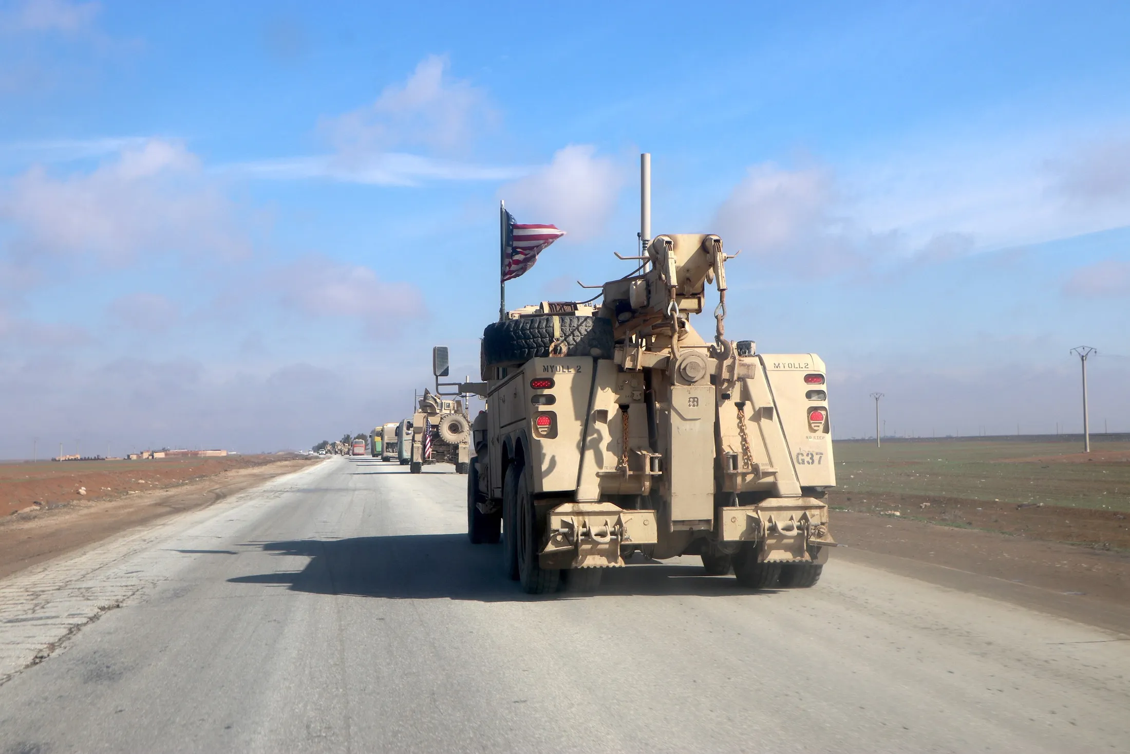 US&nbsp;military vehicles escort passenger buses transporting Islamic State IS detainees from northeastern Syria into Iraq on Feb. 8.