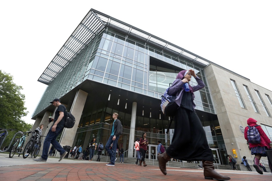 Students walk by a library on the campus of Virginia Commonwealth University in Richmond, Virginia.