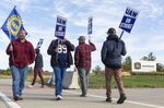 Deere & Co. workers strike outside the John Deere Des Moines Works facility in Ankeny, Iowa, on Oct. 15. 