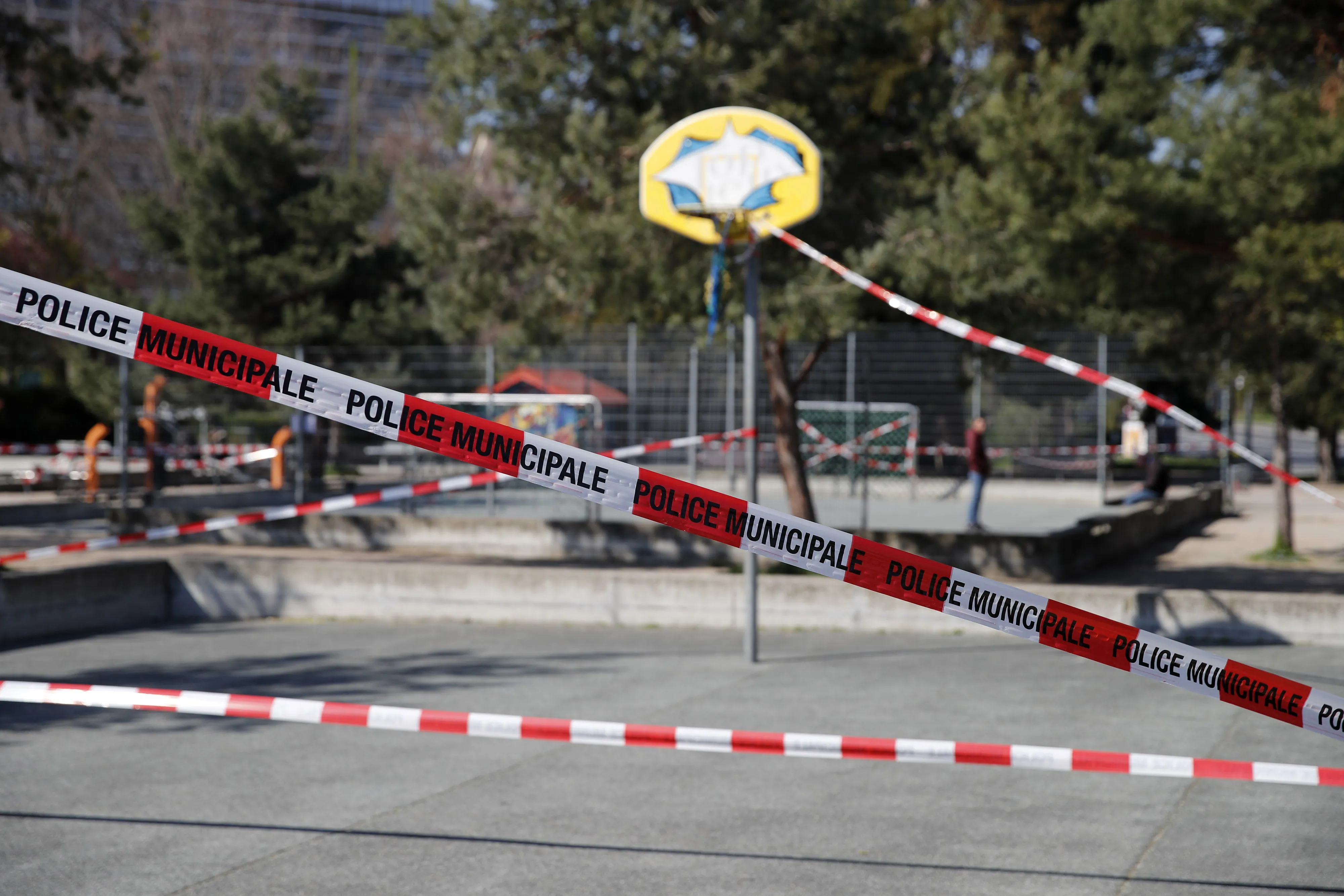 Police tape cordons off a baskeball court equipment in Geneva on March 25.