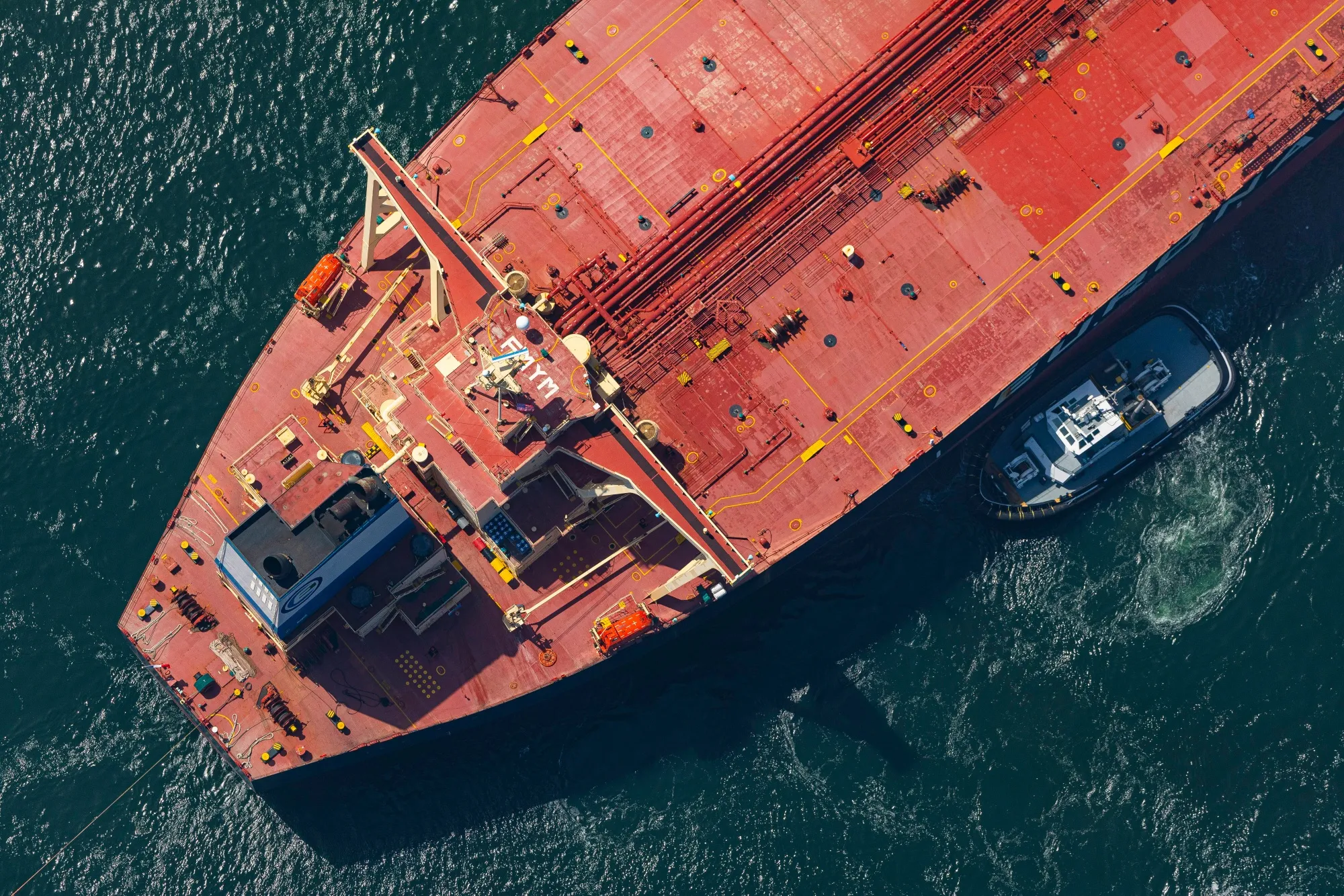 A tug boat assists an oil tanker at the Port of Long Beach in California.