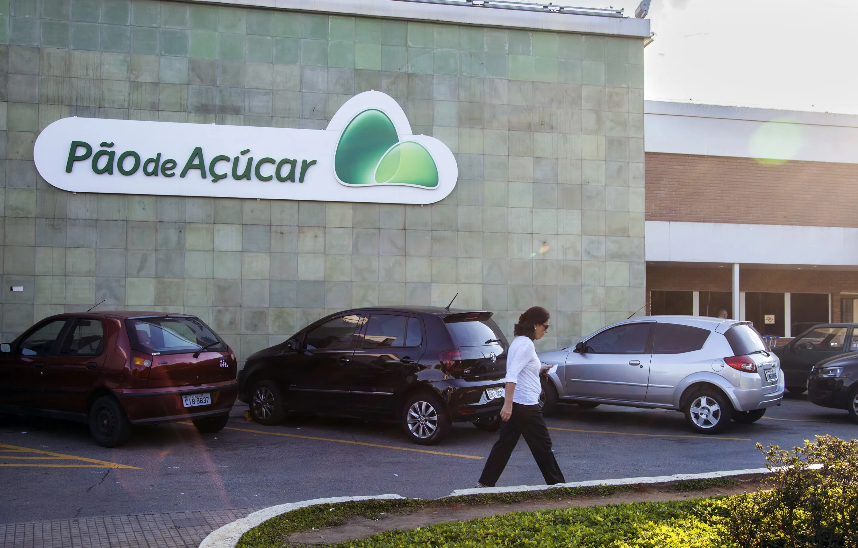 A person walks in the parking lot of a Cia. Brasileira de Distribuicao Grupo Pao de Acucar grocery store in Sao Paulo.