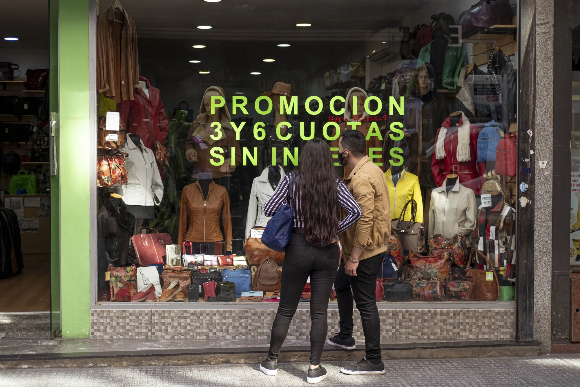 Shoppers stand in front of a store in the San Nicolas neighborhood of Buenos Aires, Argentina, on Thursday, Sept. 17, 2020.