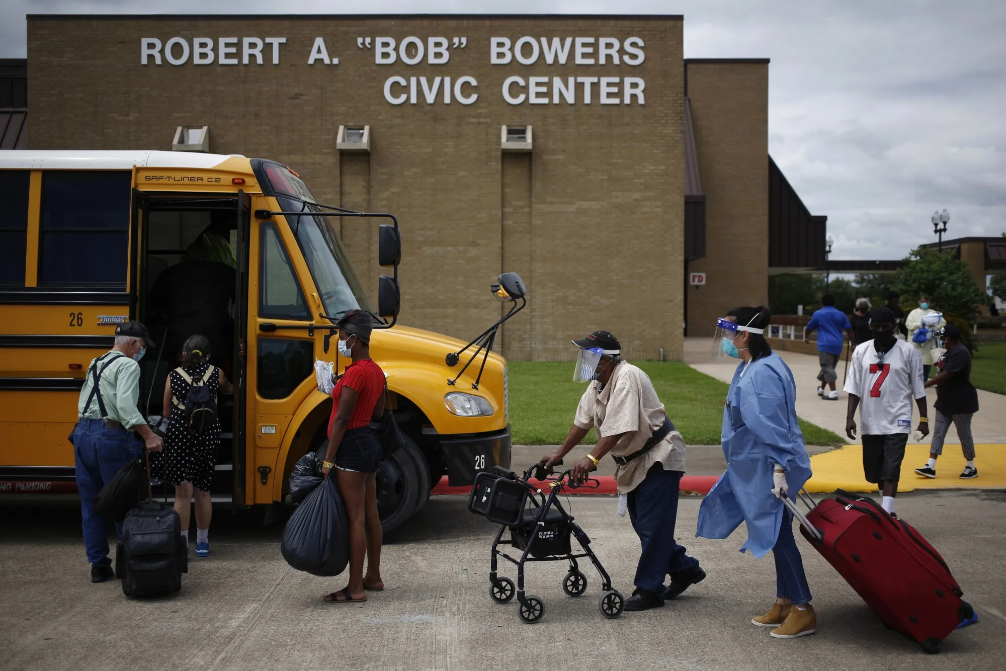 Residents of Port Arthur board a bus to evacuate ahead of Hurricane Laura on Aug. 25. The area was hard hit by Hurricane Harvey in 2017, and disparities in recovery aid have left enduring effects.&nbsp;