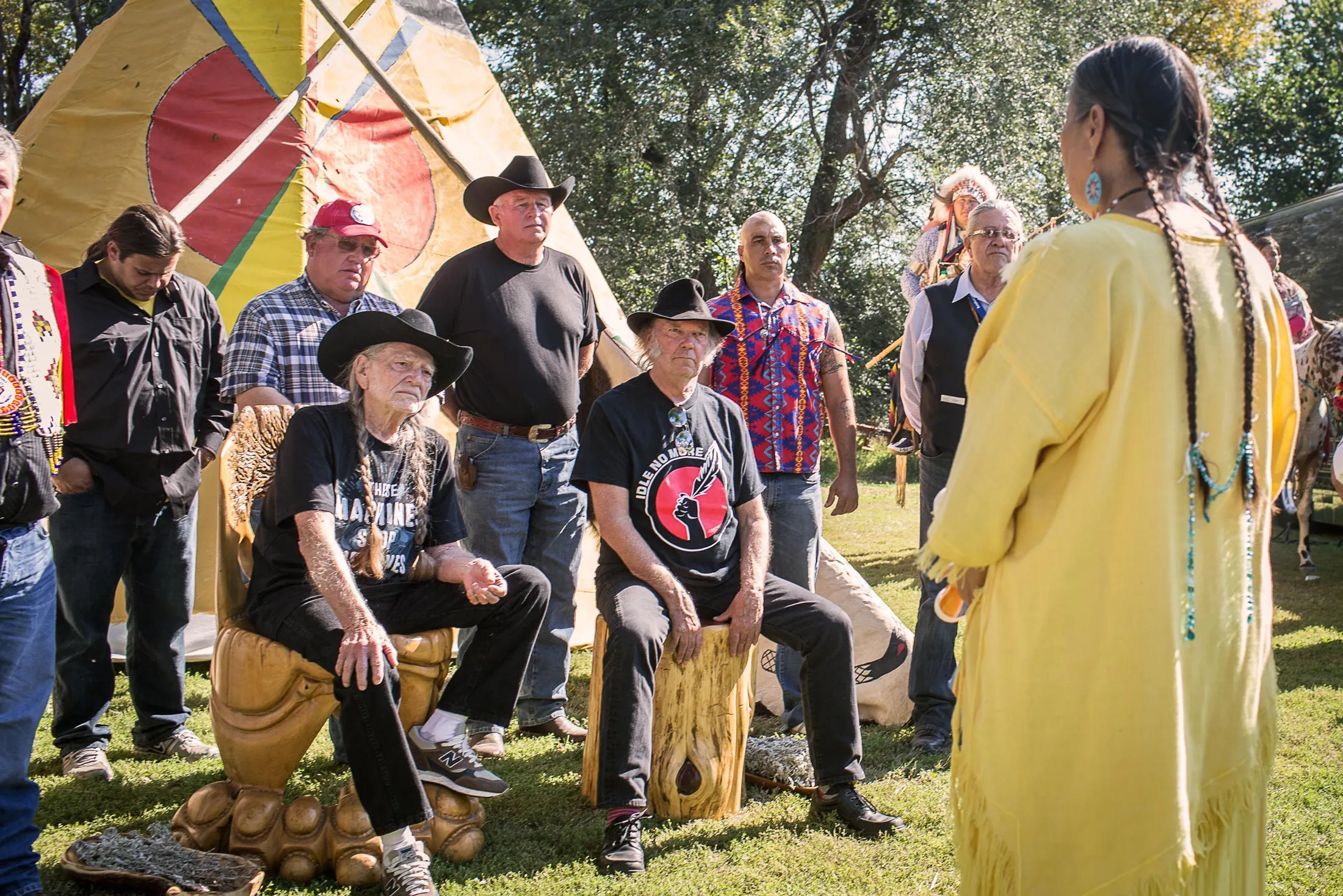 Willie Nelson (seated left)&nbsp;and Neil Young honored by the Rosebud, Oglala, Ponca, and Omaha&nbsp;Nations for their dedication to family farmers, ranchers, and native families, on Sept. 27, 2014.&nbsp;