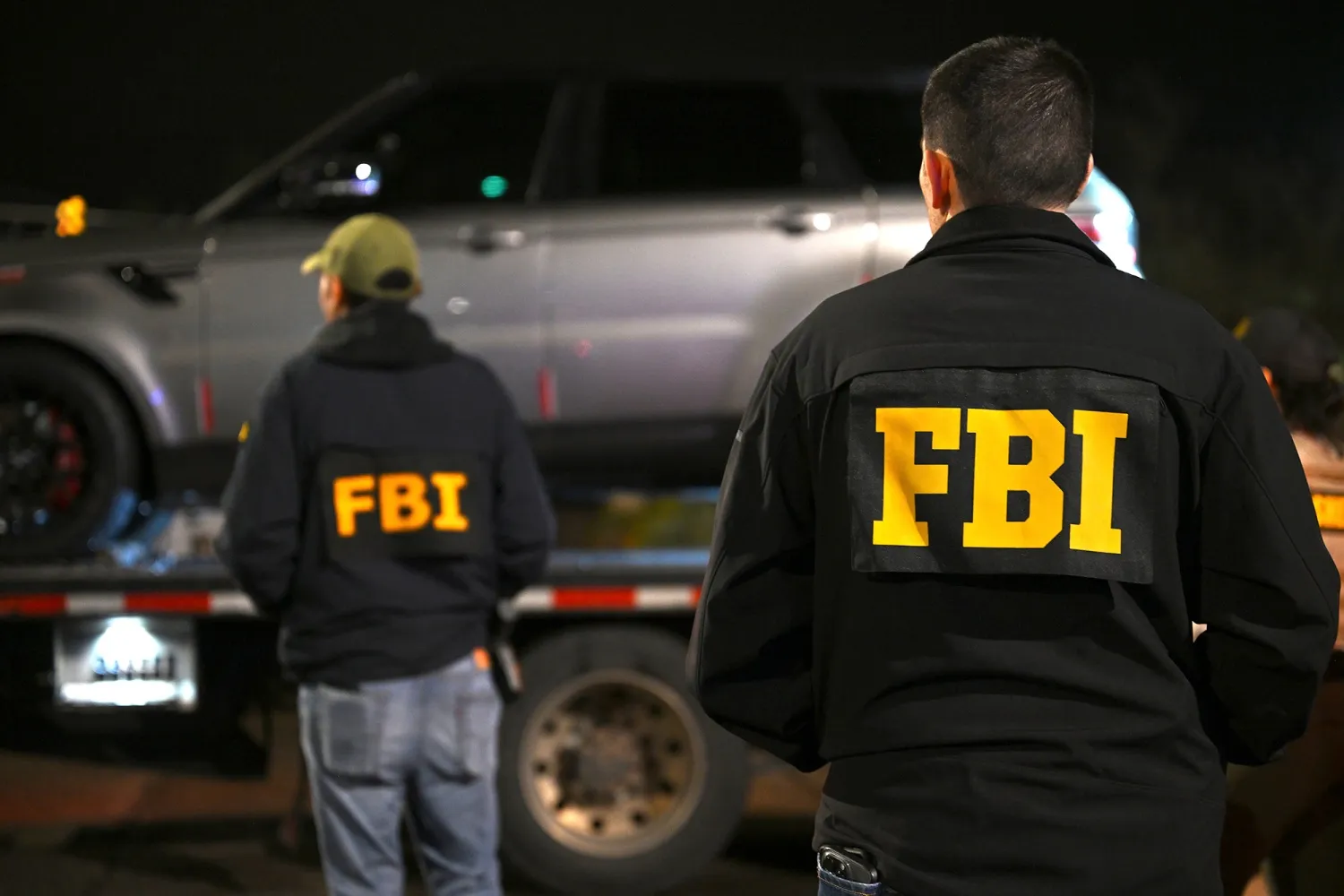 FBI agents watch as a vehicle is towed from the parking lot&nbsp;in Tucson, Arizona.