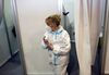A health care worker carries boxes of the Sinopharm Group Co Ltd. Covid-19 vaccine at a vaccination site in the Belgrade Fair exhibition center, on Jan. 19.