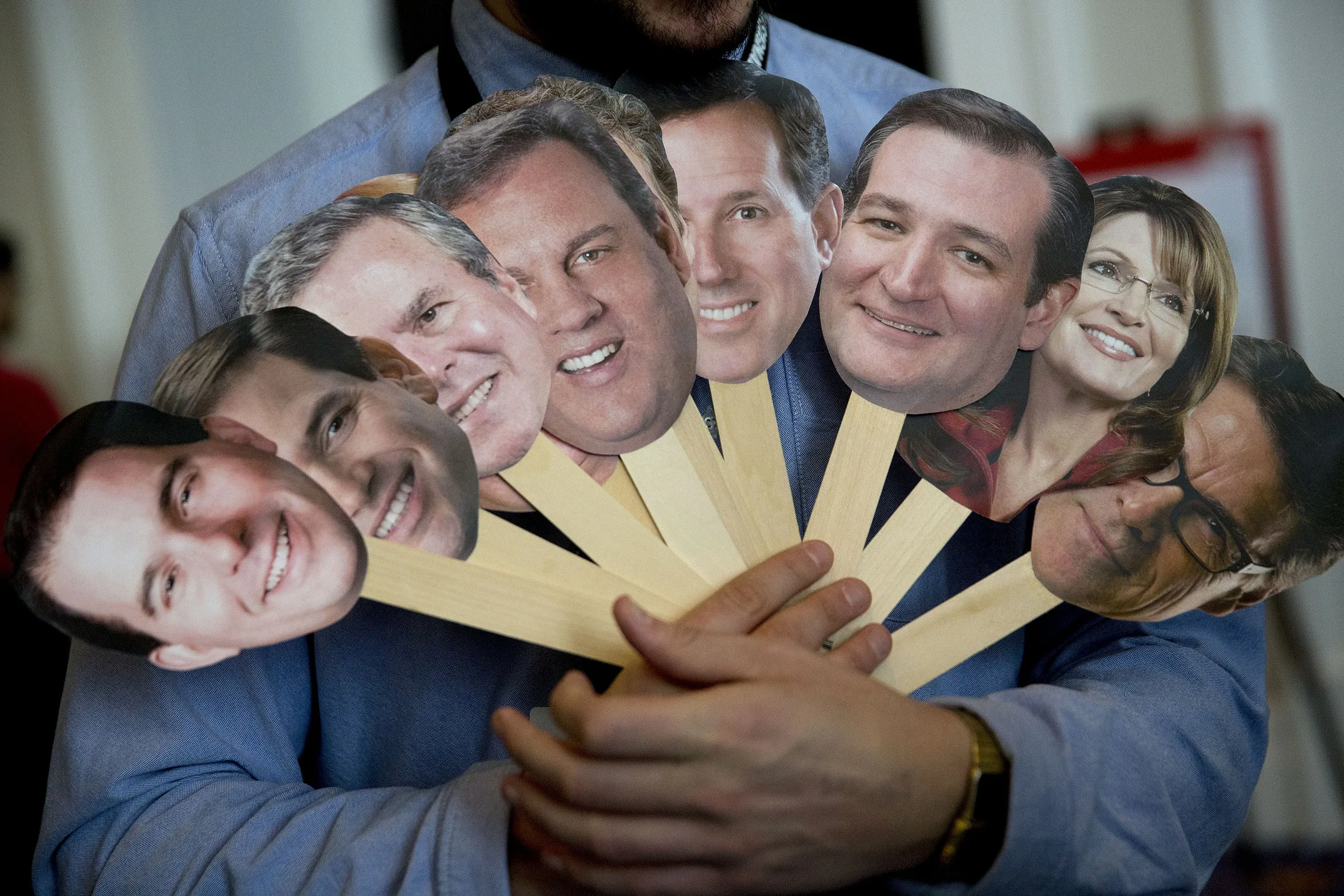 Attendee Adam Gabbatt holds photos of possible presidential candidates to question attendees during the Conservative Political Action Conference (CPAC) in National Harbor, Maryland, U.S., on Thursday, Feb. 26, 2015.
