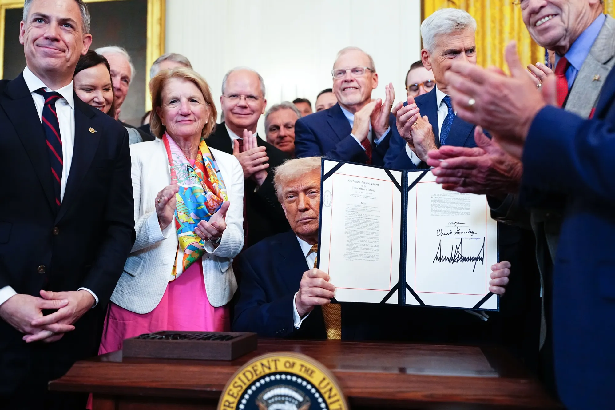 US President Donald Trump, center, displays the signed Halt All Lethal Trafficking of Fentanyl Act during a ceremony in the East Room of the White House in Washington, DC, US, on Wednesday, July 16, 2025.