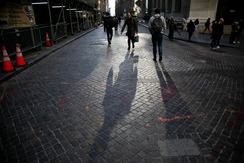 Pedestrians on Wall Street near the New York Stock Exchange (NYSE) in New York, US.