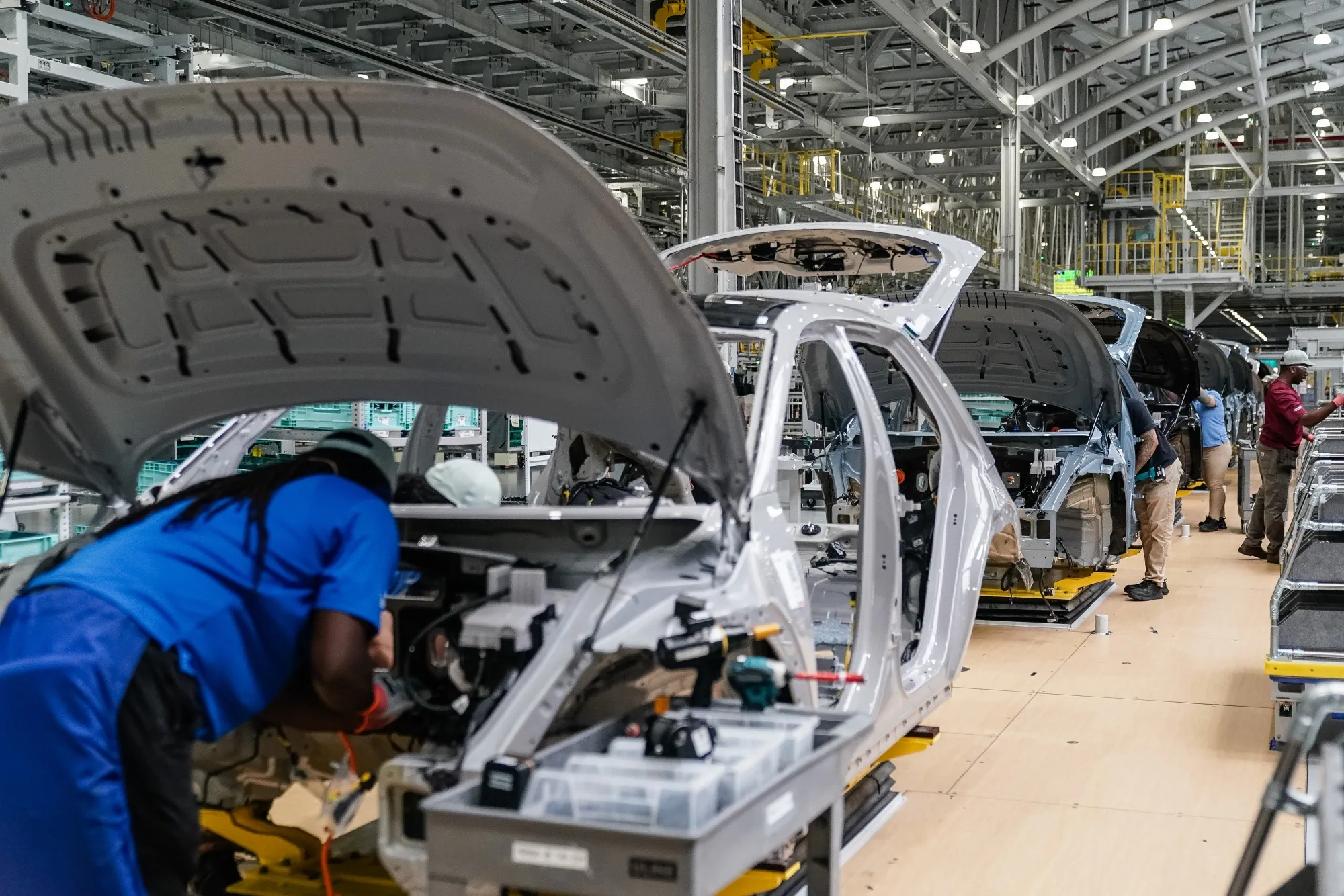 Workers assemble vehicles on the production floor at a&nbsp;vehicle manufacturing facility in Ellabell, Georgia.