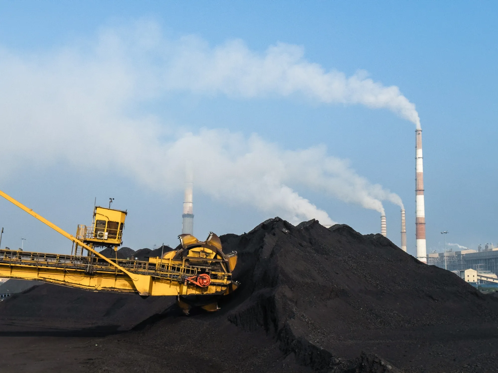 A stacker-reclaimer operates on a stockpile of coal at the NLC Tamil Nadu Power Ltd.&nbsp;power plant in Tuticorin, India, in March 2024.