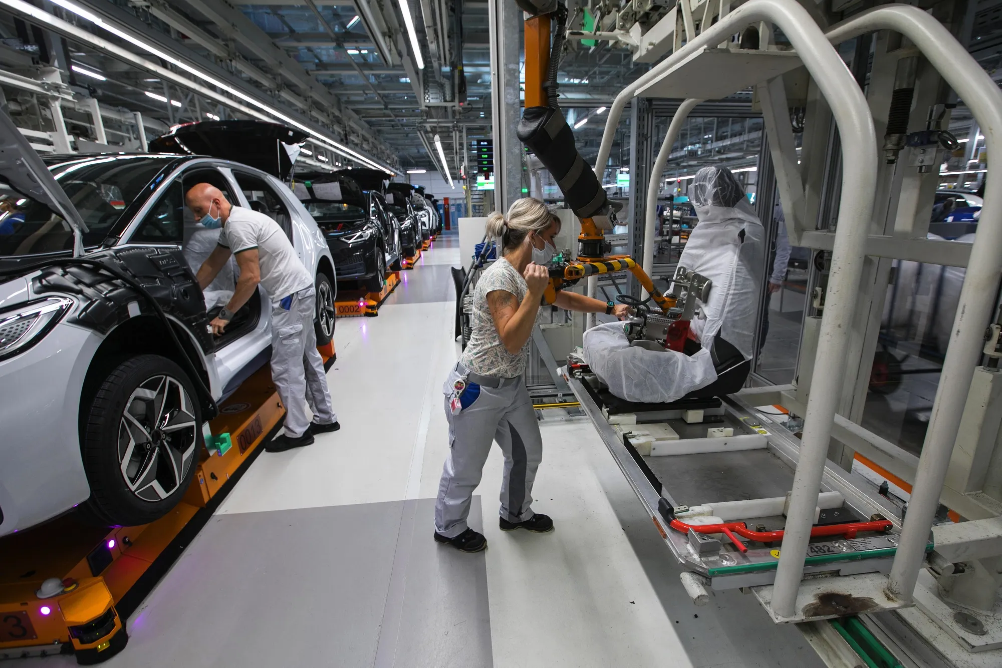 Workers fit seats to a Volkswagen AG ID.3 electric vehicle on the assembly line at company’s factory in Zwickau, Germany.