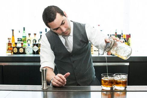 Bartender Gabe Solano pours St. Cloud's signature "New Amsterdam" cocktail, a variation on the classic Negroni.