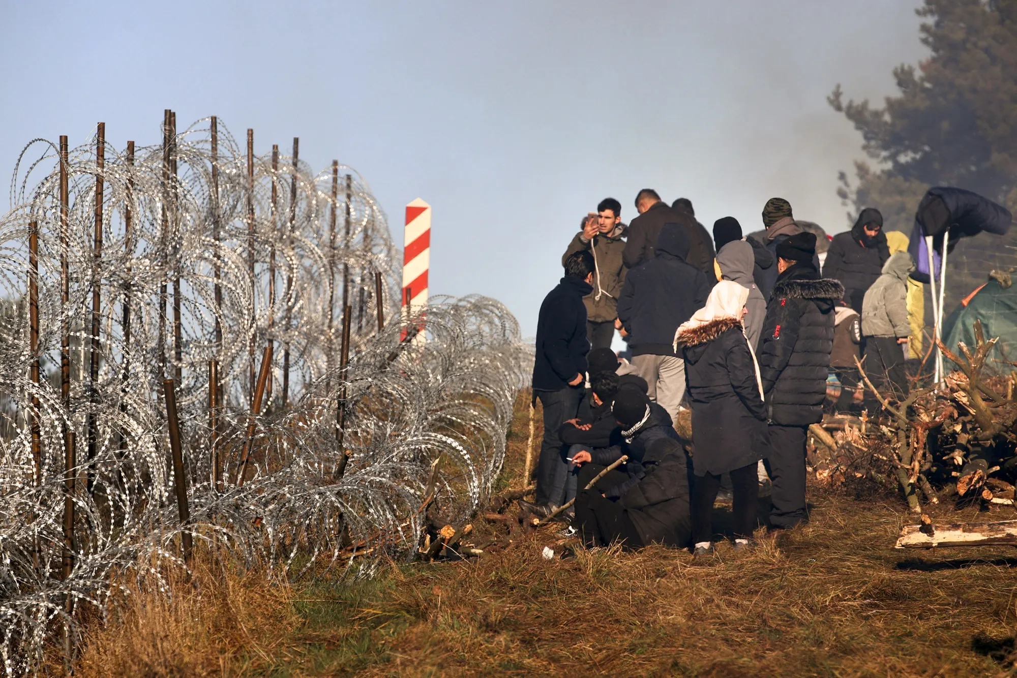 Migrants gather near razor wire on the Belarus-Poland border near Grodno, on Nov. 9.