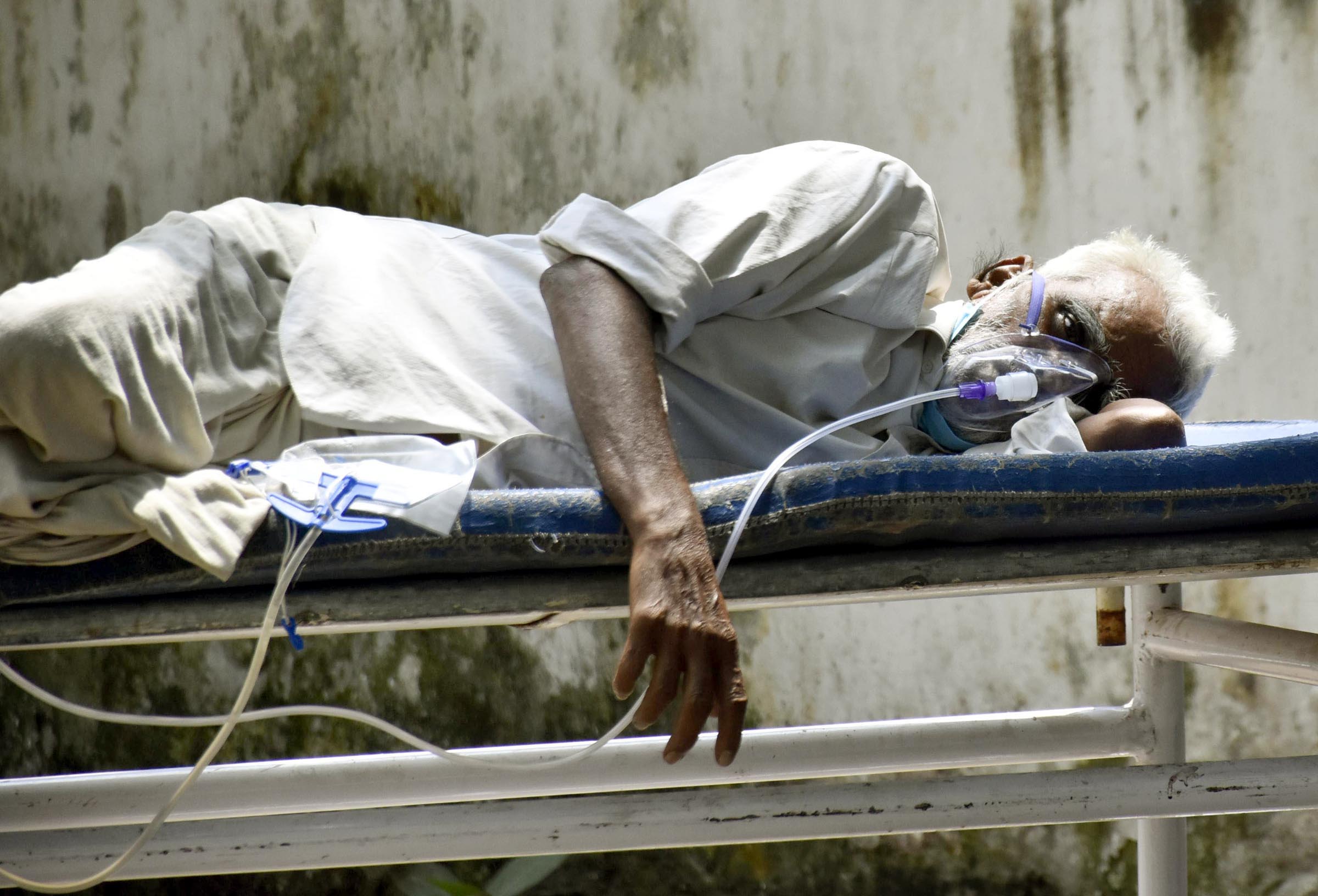 A Covid-19 patient on oxygen support waits to be admitted outside Patna Medical College & Hospital, on May 14.