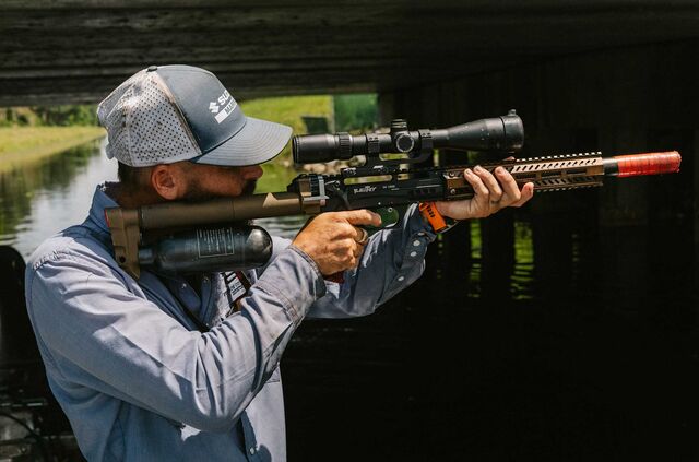 Kimmel takes aim at an iguana.
