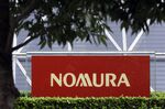 Signage for Nomura Holdings Inc. outside its headquarters in Tokyo, Japan, on Monday, March 29, 2021. 