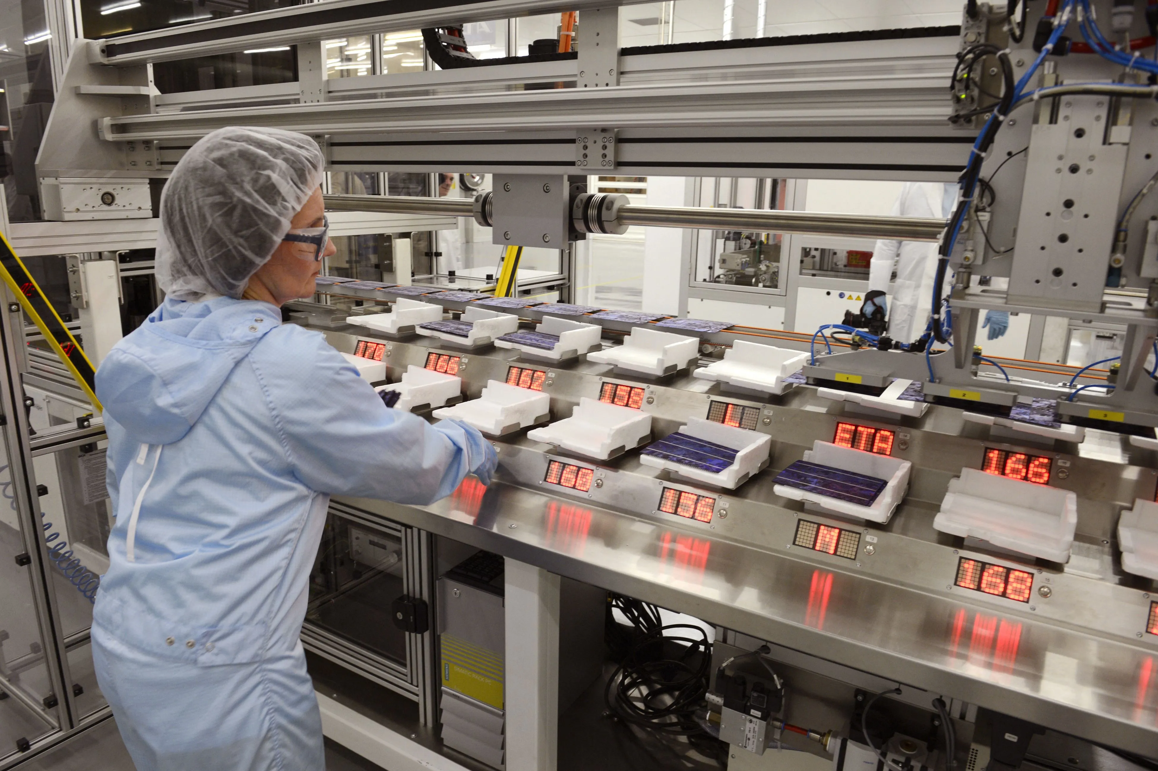 A woman works on a manufacturing robot of&nbsp;solar panel maker in Bourgoin-Jallieu, France.&nbsp;