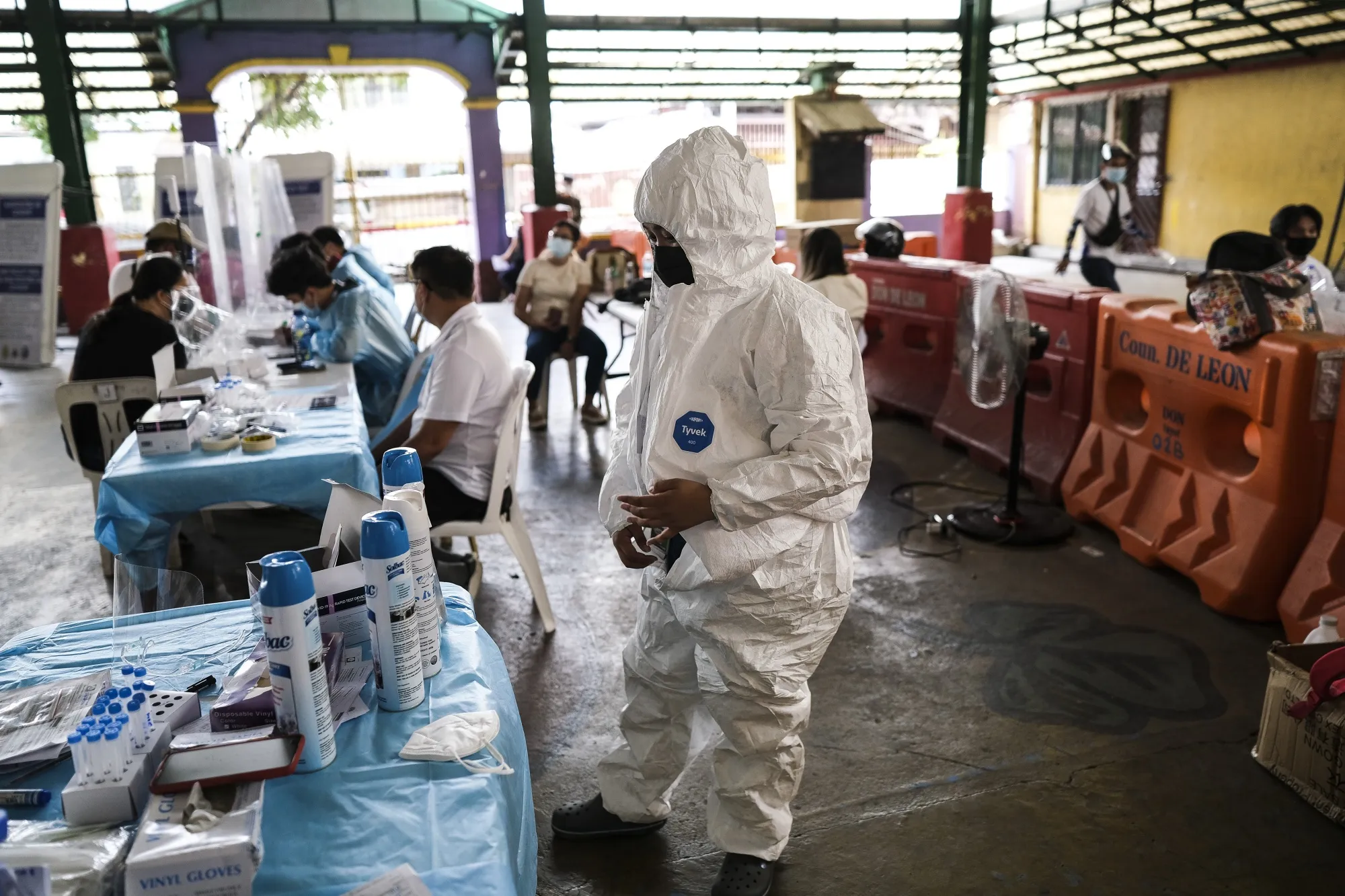 A health worker puts on personal protective equipment at a Covid-19 test site in Quezon City, Metro Manila, on May 11.
